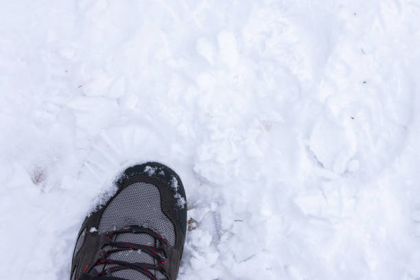 istock foot with hiking boot on snow 1438346032