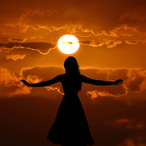 istock Spreading arms woman at sunset 1438346085