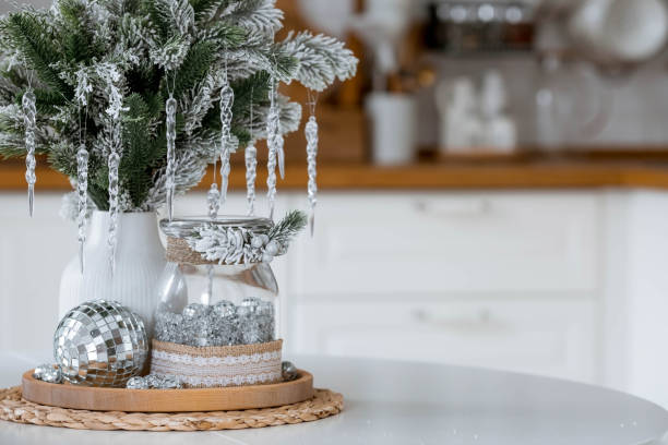 istock A spruce bouquet with icicles on a white kitchen table. Christmas decorations in the interior. The concept of preparing for the New Year holiday. 1438346355
