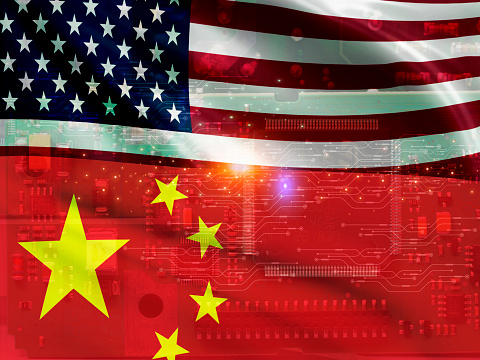 Chip shortage and US-China trade conflict. Global chip shortage crisis and China-United States trade war concept. China flag and US flag on computer chip background. Chip and semiconductor trade war.
