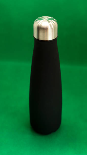 istock black aluminum bottle on green background 1438348192