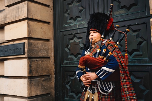 edinburgh, United Kingdom – July 23, 2022: A closeup of a bagpipe street performer at the Royal Mile in Edinburgh, Scotland