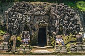 istock Entrance of Goa Gajah Elephant Cave with carvings of faces in Bali, Indonesia 1438349908