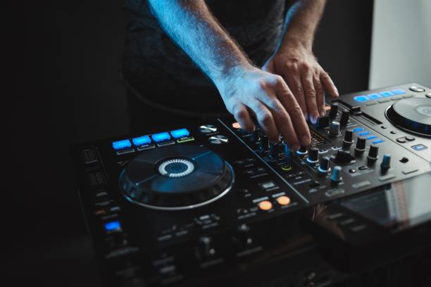 istock Closeup of a DJ working under the lights against a dark background in a studio 1438351290