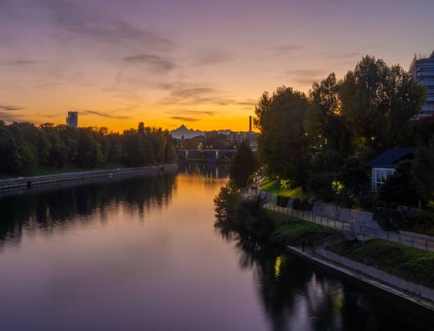 istock Scenic river running through a town during sunset surrounded by vegetation 1438351913
