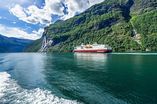 Geiranger, Norway – August 14, 2018: Hurtigruten cruise liner sailing on the Geirangerfjord, one of the most popular destination in Norway. Geiranger, Norway, August 2018
