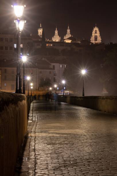 istock Illuminated Charles Bridge below the castles at night in Prague, Czechia 1438352559