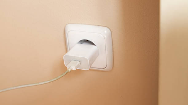 istock white charger plugged into power 1438353285