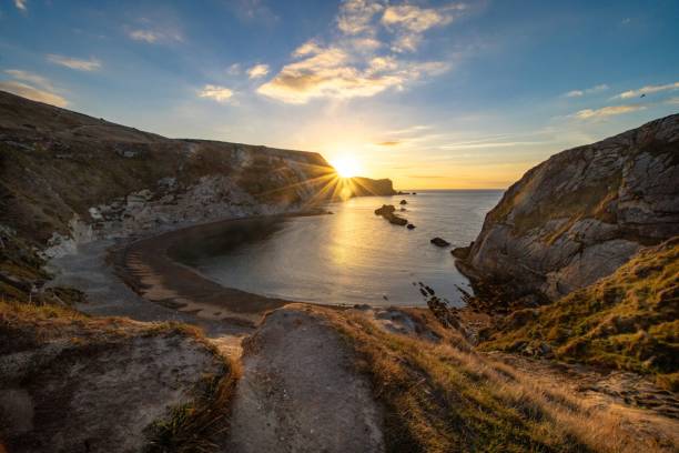 istock Beautiful shot of a lake coast surrounded by cliffs during sunset 1438353334