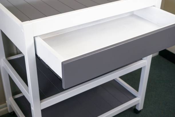 istock Closeup of a modern white table with a drawer under the lights 1438353613