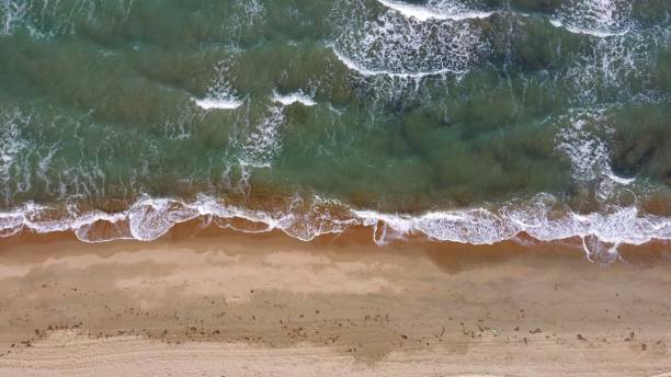 istock Top view shot of ocean waves crushing on the shore 1438353621