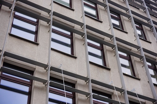 A low angle shot of the facade of a residential building with many windows