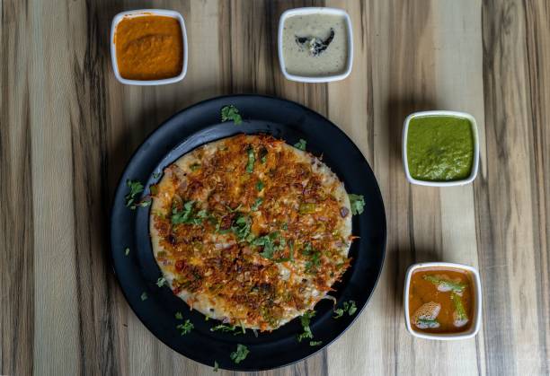 istock Flatbread with meat on a round plate decorated with sauces on a wooden table 1438354411