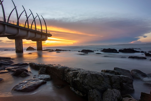 A bridge on the beach at sunset, long exposure