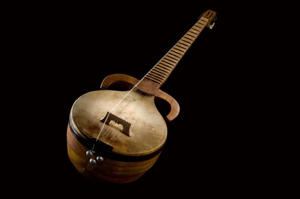 istock Ancient Asian stringed musical instrument on a black background 1438355445