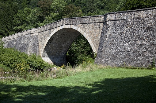 A panoramic shot of Casselman Bridge in Garrett County, Maryland during summer