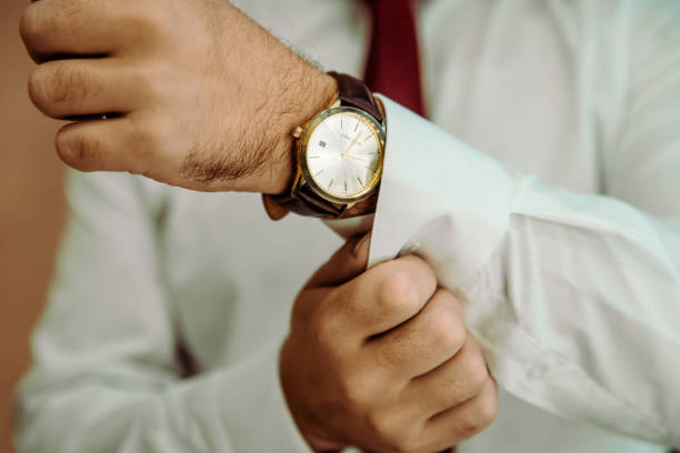 istock man putting clock on hand,groom getting ready in the morning 1438357760