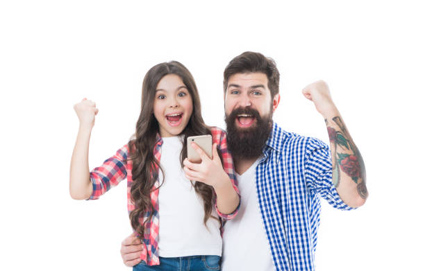 istock We won. Happy family celebrate victory using smartphone. Victory is ours 1438358318