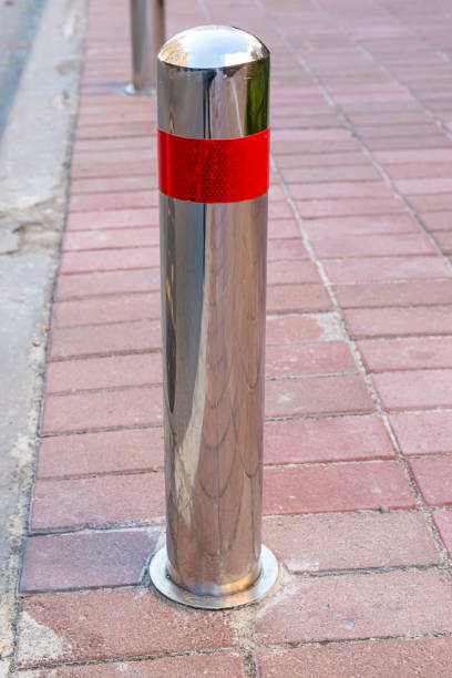 istock Stainless parking poles separating the sidewalk from the road. 1438359104