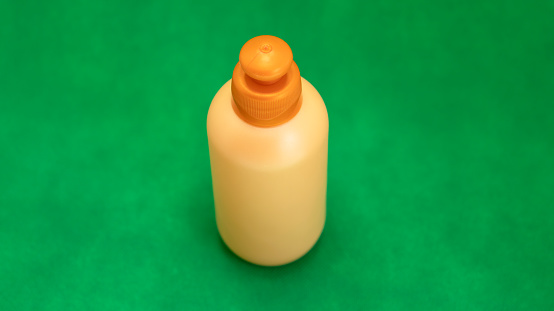 orange container for soap or cream seen from above