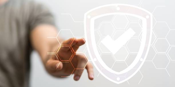 istock Businessman presenting a virtual projection of an emblem with a verification sign 1438359989