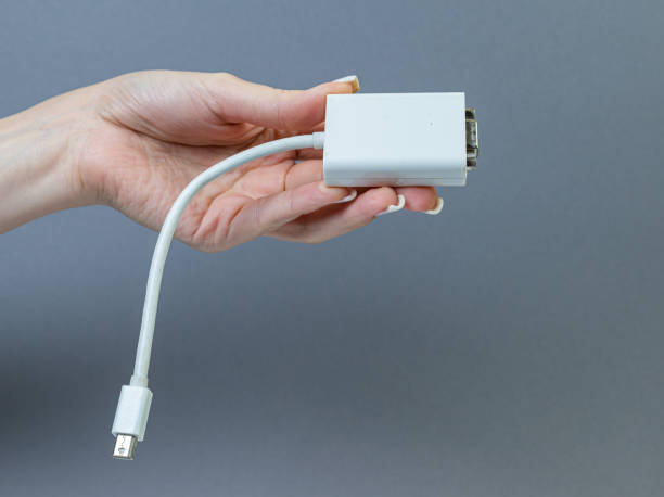 istock Hands holding various converter cables adapters for computers and smartphones 1438361019