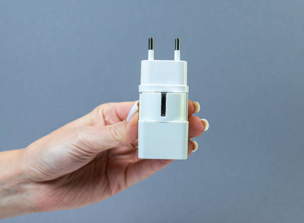 istock Hands holding various converter cables adapters for computers and smartphones 1438361058