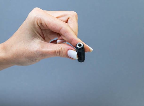 istock Hands holding various converter cables adapters for computers and smartphones 1438361079