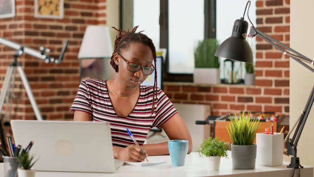 istock Business student taking notes at online class lesson on laptop 1438361113