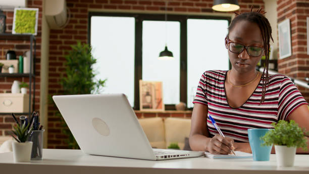 istock Business student taking notes at online webinar class on laptop 1438361386