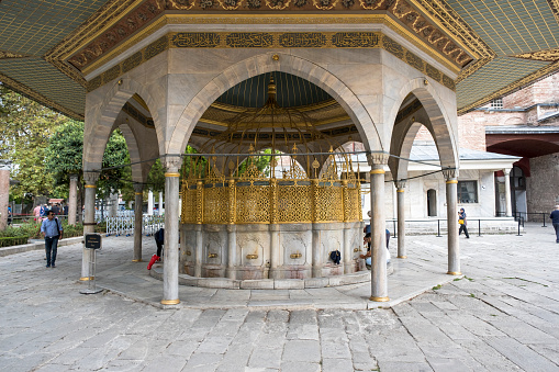 Istanbul, Turkey 09-27-2022 : inside the Hagia sophia mosque yard and garden. Fountain built in 1740 in the garden of Hagia Sophia