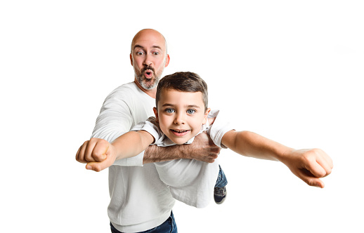 Gay male parents having fun with their son outdoor - Focus on kid boy face