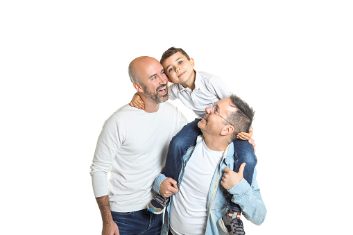 A two man couple with adopted child on white background