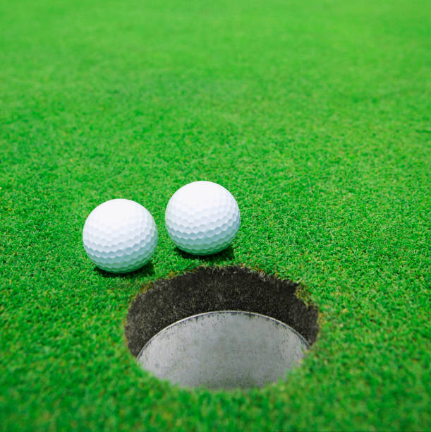 istock The balls at the hole on the golf course 1438365009