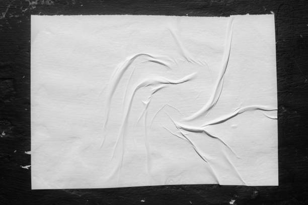 istock Paper with folds on a black wall. 1438365028