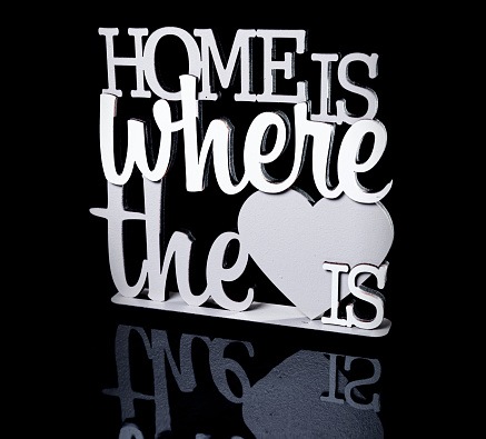 wooden vintage frame WELCOME HOME over black isolated Home sweet home Home is love