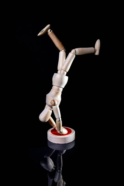 istock Image of wooden manikin on black background poses different posing 1438365496
