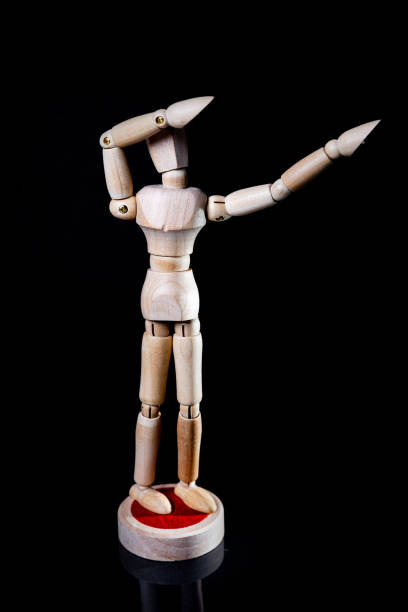 istock Image of wooden manikin on black background poses different posing 1438365515