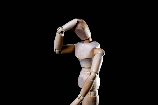 istock Image of wooden manikin on black background poses different posing 1438365524