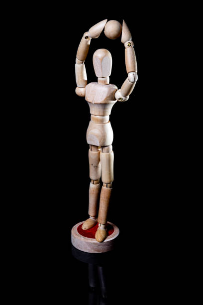 istock Image of wooden manikin on black background poses different posing 1438365525