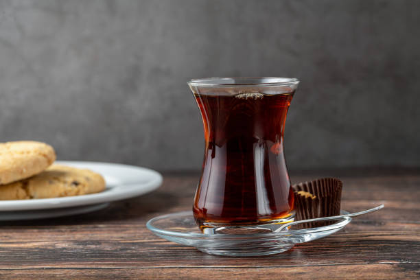 istock Freshly brewed black Turkish tea with cookies on wooden table 1438366830