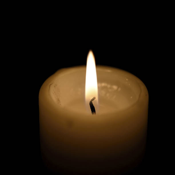 istock Candle composition, various rituals. Close-up light of one candle and flame on black background 1438366953