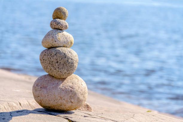 Pyramid of stones. Unstable balance of stone objects. stock photo