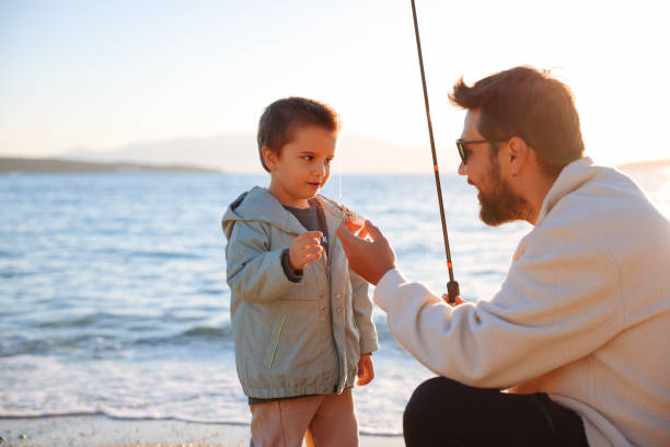 istock A young father with a small toddler son outdoors fishing by a lake 1438368708