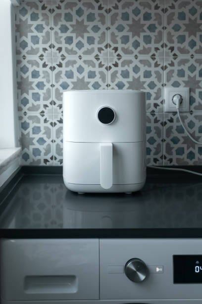 istock Air fryer machine in domestic kitchen. Technology home smart device vertical 1438368712