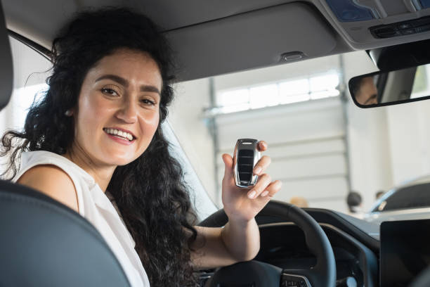 Businesswoman satisfied with purchase and shows car key