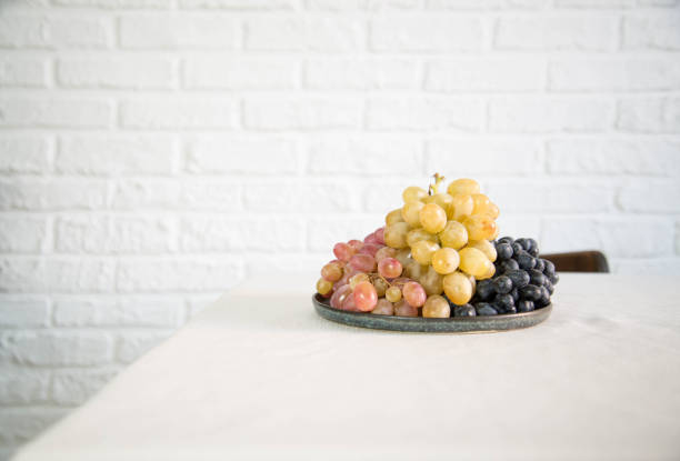 Fresh grapes are on the table in light background.