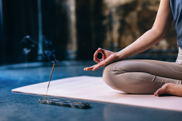 An Anonymous Woman Enjoying Incense Stick During Yoga Session