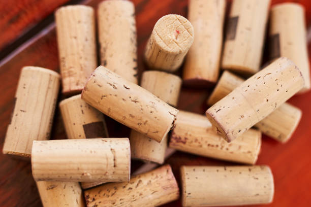 Background, wine and cork with a collection or group of alcohol caps or objects on a red background from above. Texture, wood and luxury with many corks in a pile or stack on a wine farm and cellar Background, wine and cork with a collection or group of alcohol caps or objects on a red background from above. Texture, wood and luxury with many corks in a pile or stack on a wine farm and cellar cork stopper stock pictures, royalty-free photos & images