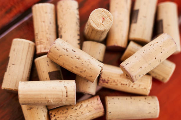 background, wine and cork with a collection or group of alcohol caps or objects on a red background from above. texture, wood and luxury with many corks in a pile or stack on a wine farm and cellar - wine bottle wine wood bottle stopper imagens e fotografias de stock